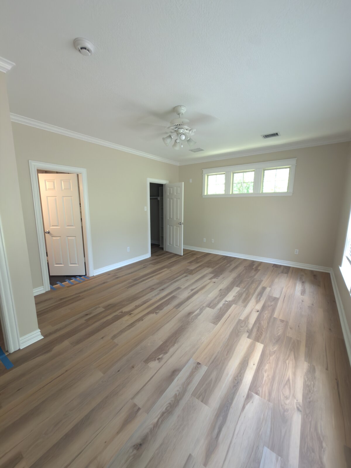 Bedroom with new plank flooring installed, Houston